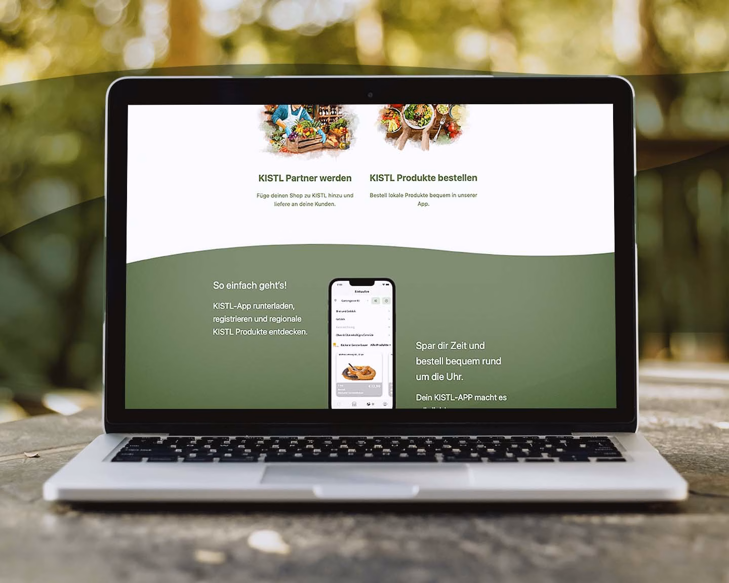 Laptop zeigt Website der KISTL-App mit Infos zur Bestellung regionaler Produkte und Partner-Option für Händler.